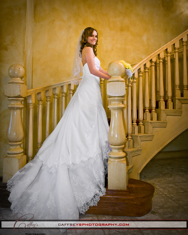 Beautiful bride on the grand staircase at Ashelynn Manor.