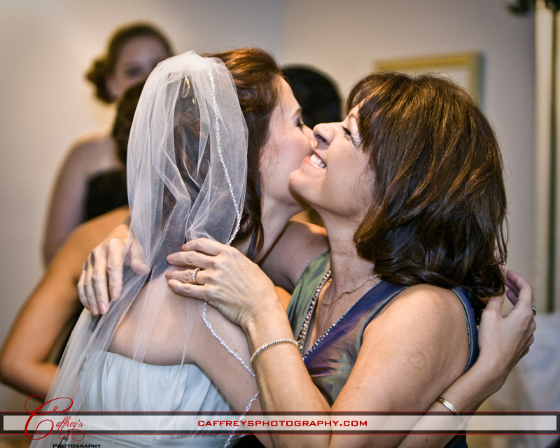 Bride hugging her mother as she gets dressed at the St Rose Of Lima Catholic Church.