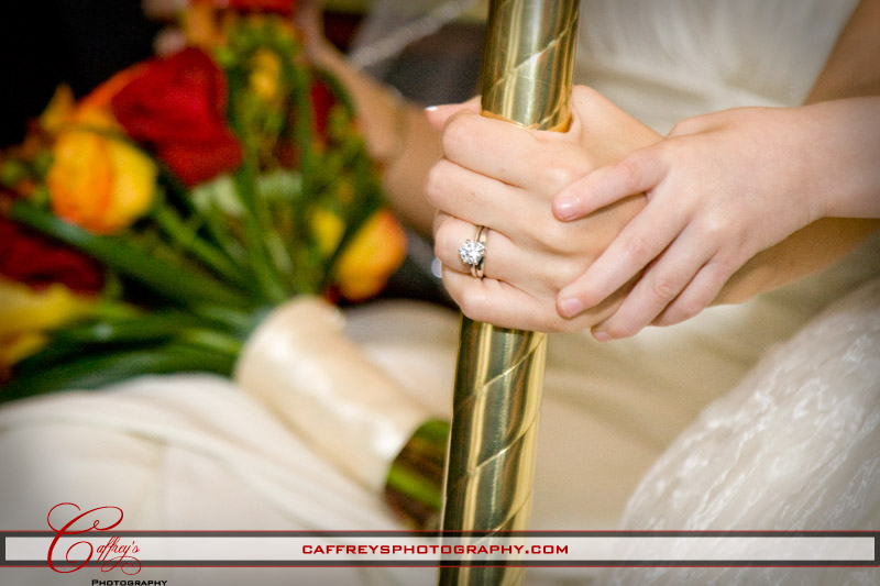 Stunning diamond wedding ring on the bride as the flower girl holds her hand.