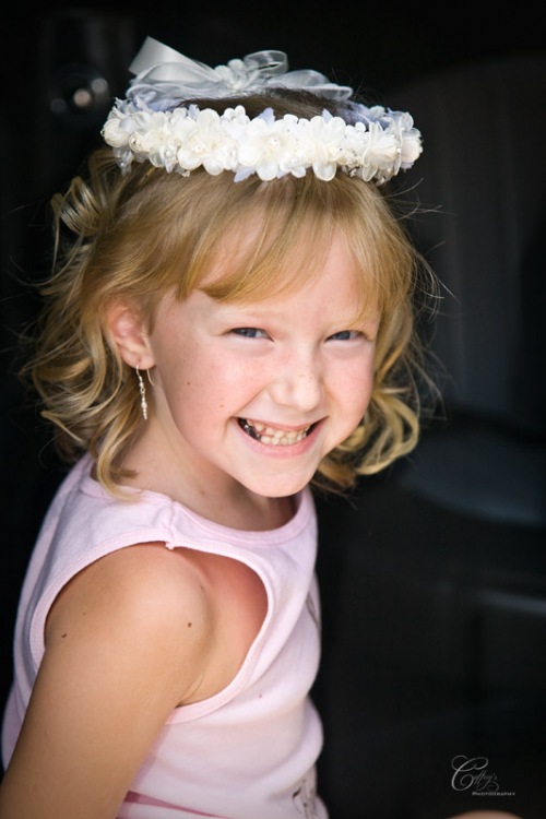 Beautiful flower girl getting ready for the wedding with a flower halo.