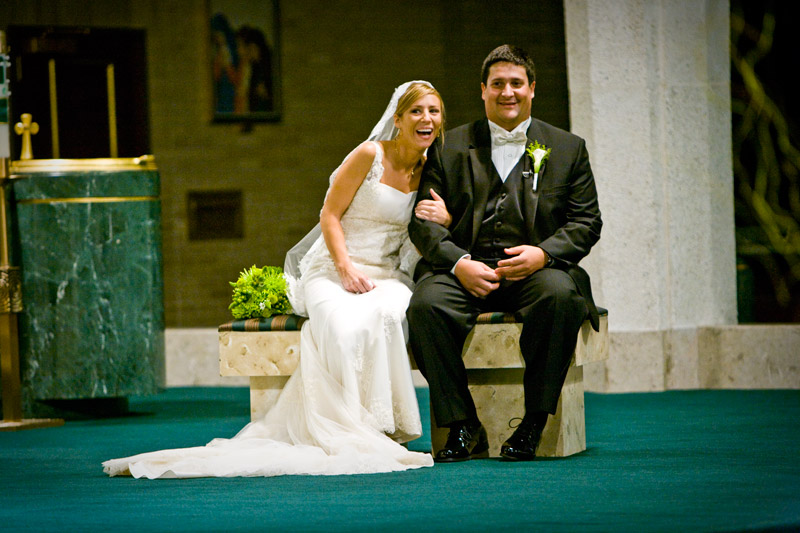 Bride and groom laughing during their wedding. 