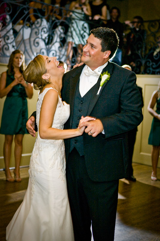 Lovely bride laughing at something her new groom said during their first dance. 