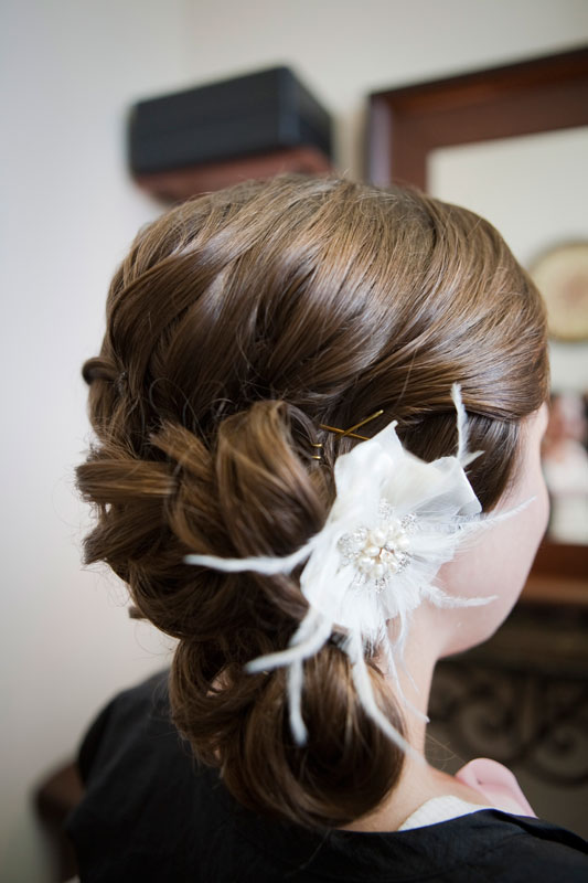 Gorgeous brides hair adorned with a flower. 
