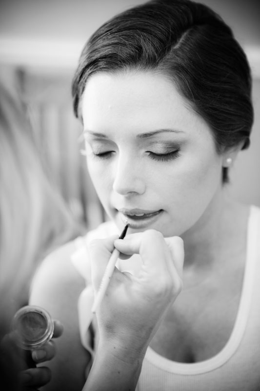 Beautiful bride having her makeup touched up before her wedding at Briscoe Manor. 