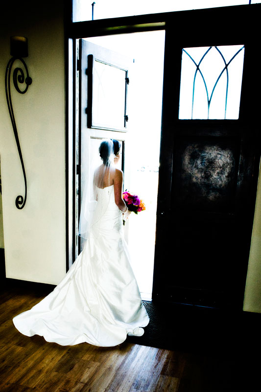 Bride looking out the doors in the chapel at Briscoe Manor. 