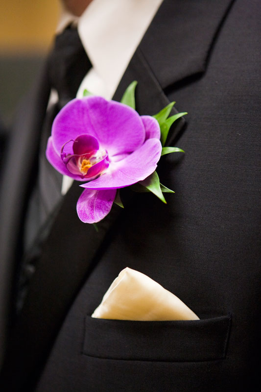 Stunning purple orchid on the grooms lapel. 