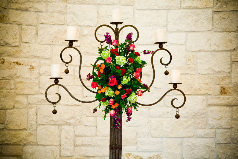 Beautiful candelabra decorated with colorful flowers at Briscoe Manor