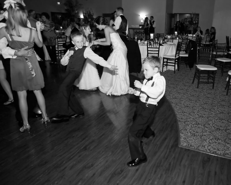 ring bearer showing his moves on the dance floor at the reception at Briscoe Manor. 
