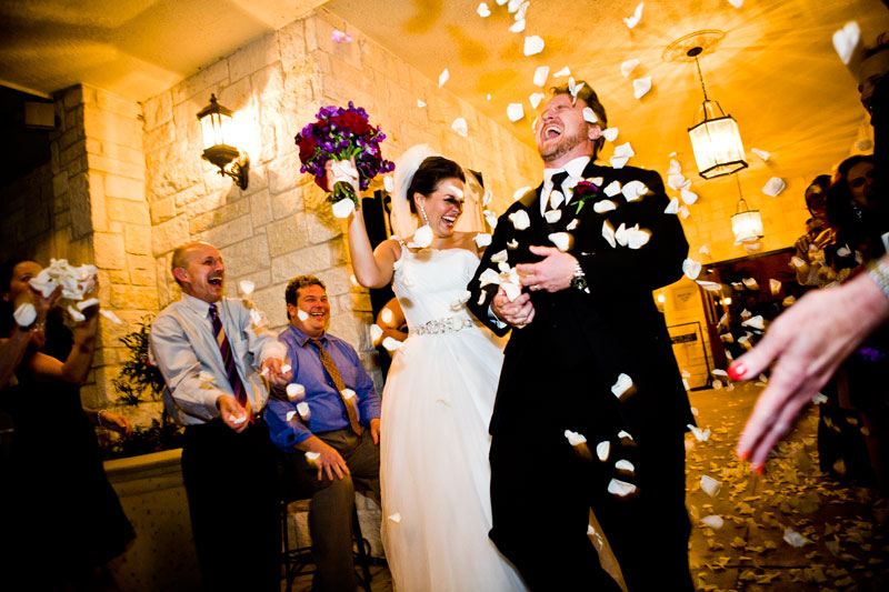 Bride and groom having a blast as they leave the reception to a rose petal toss. 