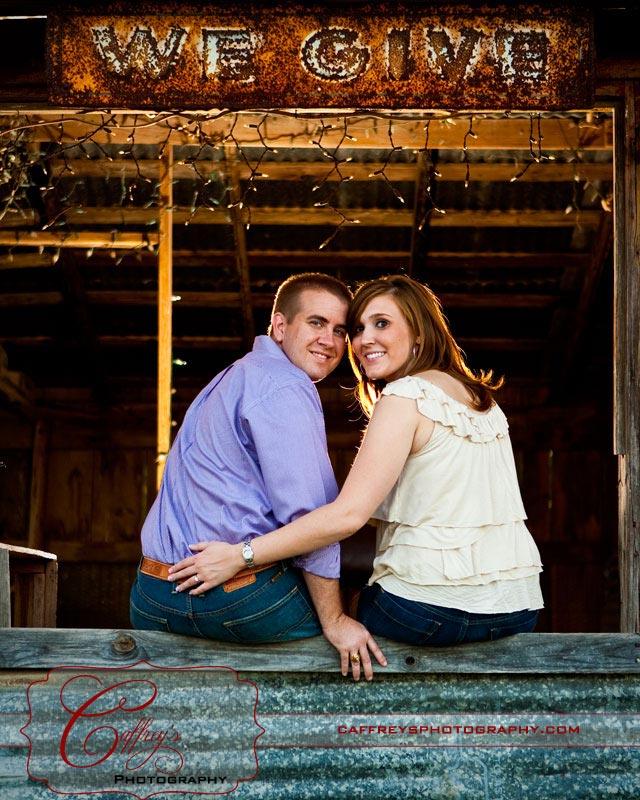 Cute couple during their engagement session in the barn. 