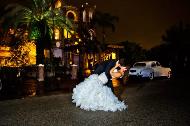 Las Velas Houston Wedding groom dipping bride by vintage car