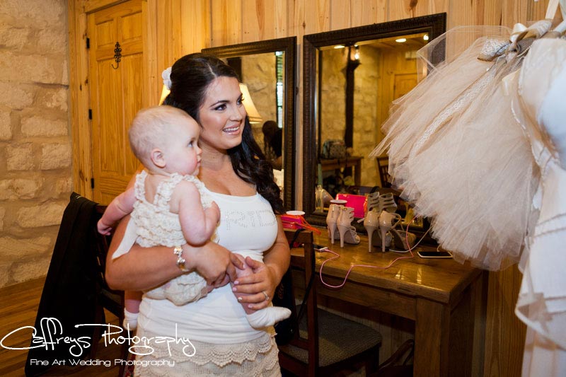 Bride and flower girl looking at dresses