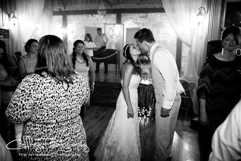 Pecan Springs Wedding Reception bride groom kiss